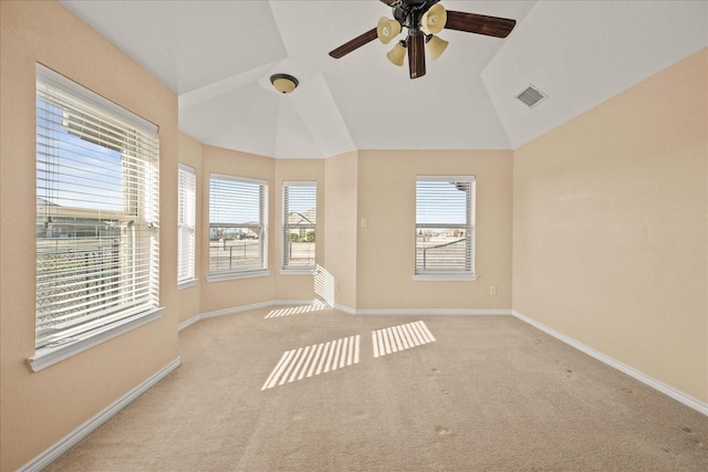 unfurnished room featuring vaulted ceiling, ceiling fan, and light colored carpet