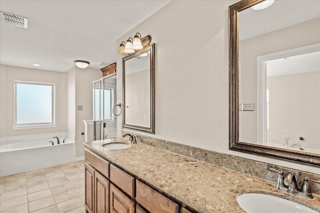 bathroom with tile patterned flooring, vanity, and shower with separate bathtub