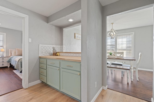 interior space featuring backsplash, a chandelier, and hardwood / wood-style flooring