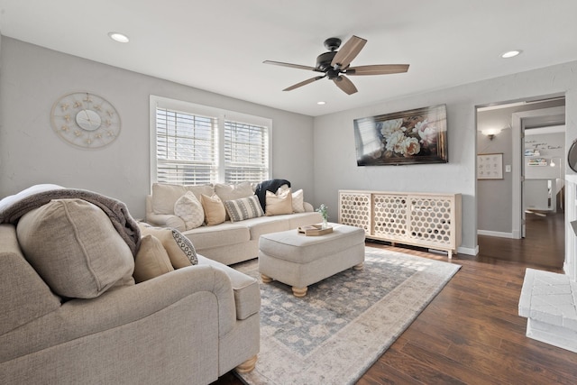 living room featuring dark hardwood / wood-style floors and ceiling fan