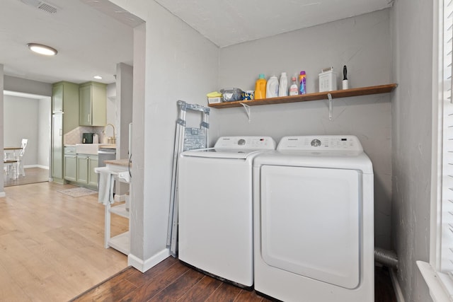 laundry room featuring dark hardwood / wood-style flooring and washer and clothes dryer