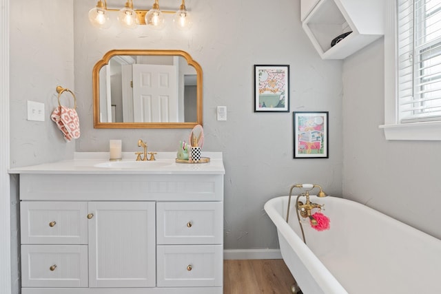 bathroom with wood-type flooring, a bath, and vanity