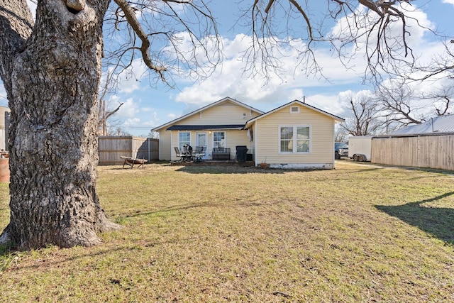 back of property featuring a yard