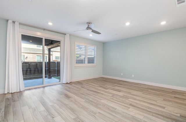 empty room featuring ceiling fan and light hardwood / wood-style flooring