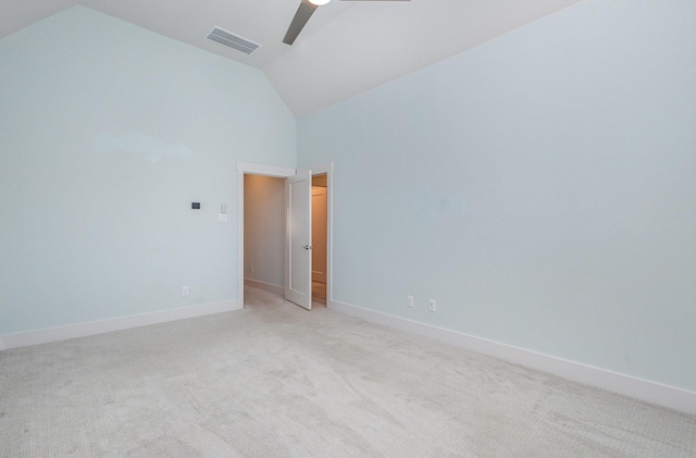 carpeted spare room with ceiling fan and high vaulted ceiling