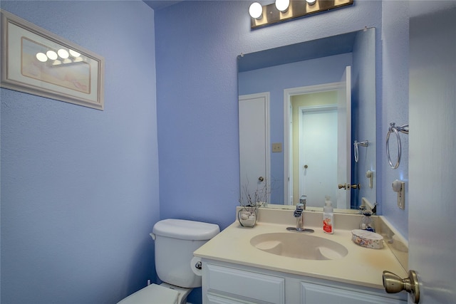 bathroom featuring toilet and vanity