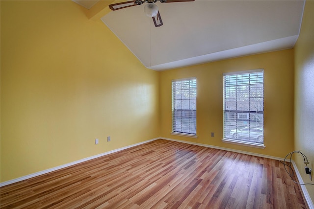 spare room with ceiling fan, lofted ceiling with beams, and light wood-type flooring