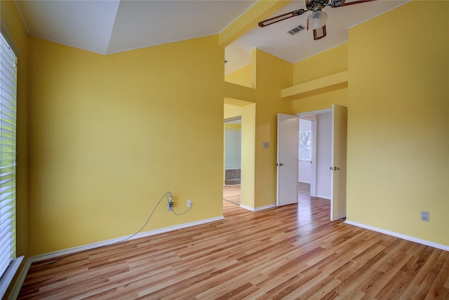 spare room featuring ceiling fan, high vaulted ceiling, and light wood-type flooring