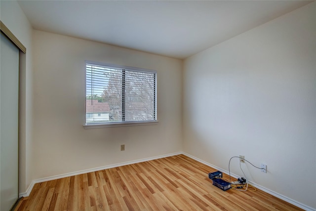 unfurnished room with wood-type flooring