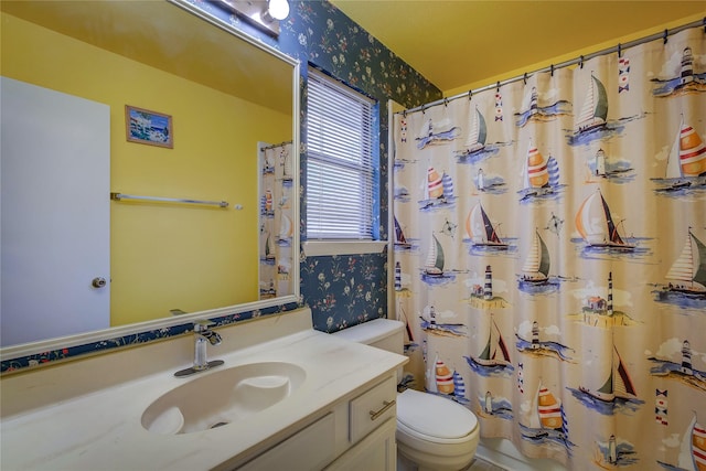 bathroom featuring toilet and vanity