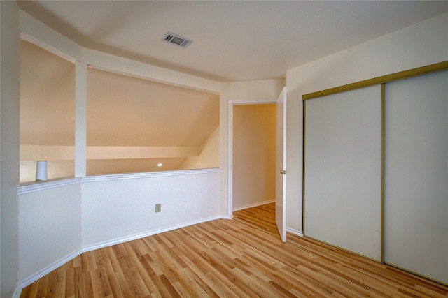 additional living space with light hardwood / wood-style floors