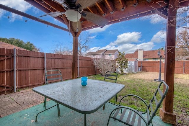 view of patio / terrace featuring ceiling fan and a storage shed