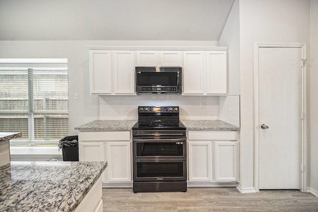 kitchen featuring white cabinets, light wood-style flooring, double oven range, and decorative backsplash