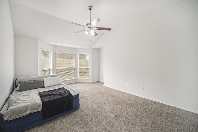 carpeted bedroom with baseboards, ceiling fan, and vaulted ceiling