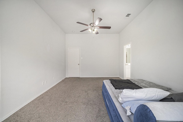 bedroom with baseboards, vaulted ceiling, carpet floors, visible vents, and ceiling fan
