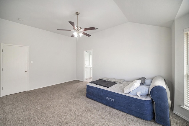 bedroom featuring connected bathroom, carpet flooring, vaulted ceiling, and a ceiling fan