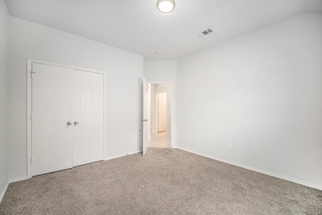 unfurnished bedroom with baseboards, visible vents, and carpet floors