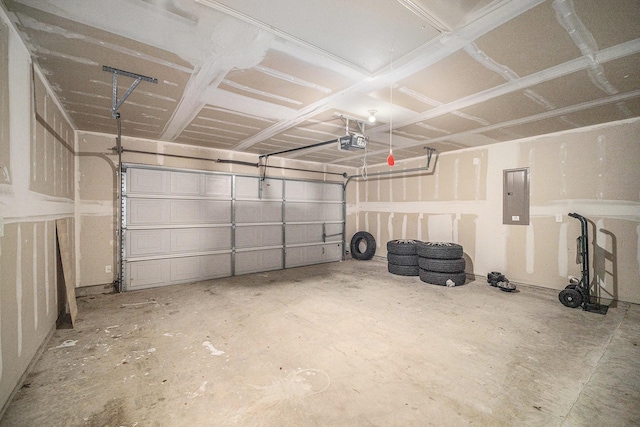 garage with a garage door opener and electric panel