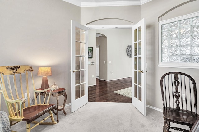 living area with french doors, ornamental molding, and carpet floors