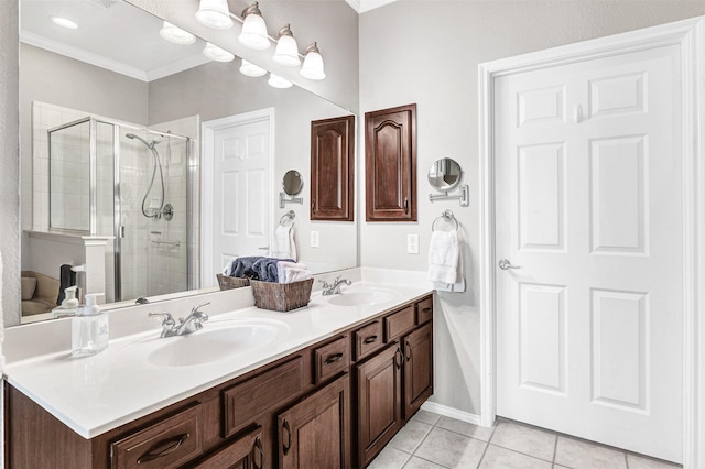 bathroom featuring a shower with door, vanity, ornamental molding, and tile patterned floors