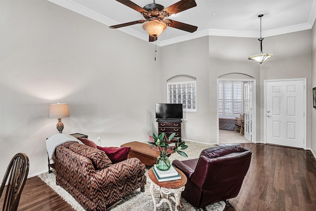 living room with crown molding, wood-type flooring, and ceiling fan