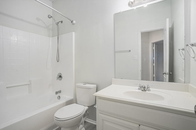bathroom with toilet, vanity, and  shower combination