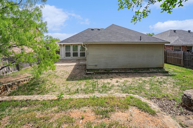 back of property featuring a fenced backyard and a patio