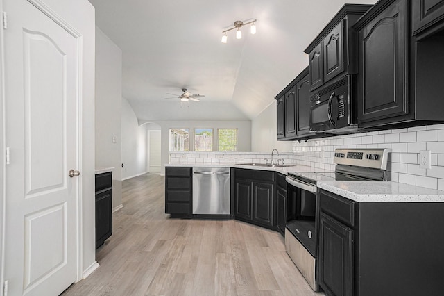 kitchen featuring tasteful backsplash, a sink, appliances with stainless steel finishes, a ceiling fan, and dark cabinets
