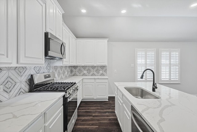 kitchen with white cabinetry, appliances with stainless steel finishes, sink, and dark hardwood / wood-style flooring