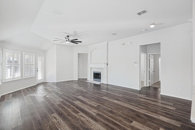 unfurnished living room featuring lofted ceiling, dark hardwood / wood-style floors, and ceiling fan