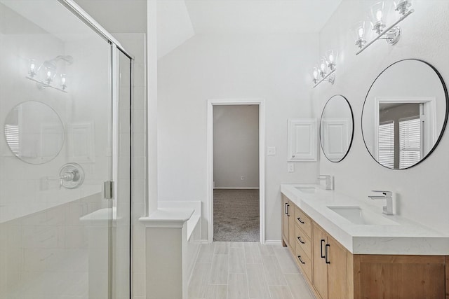 bathroom with vanity, vaulted ceiling, and walk in shower