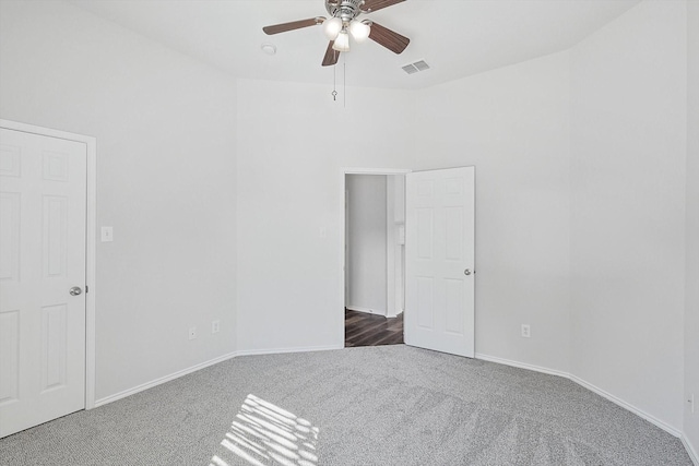 carpeted spare room with ceiling fan