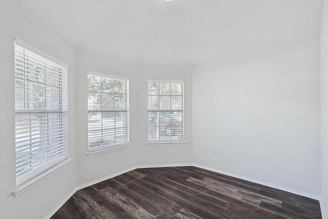 unfurnished room with dark hardwood / wood-style flooring