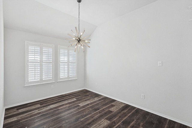 unfurnished room with dark wood-type flooring, a chandelier, and vaulted ceiling