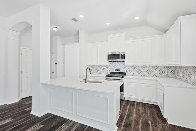 kitchen with stainless steel appliances, white cabinetry, sink, and decorative columns