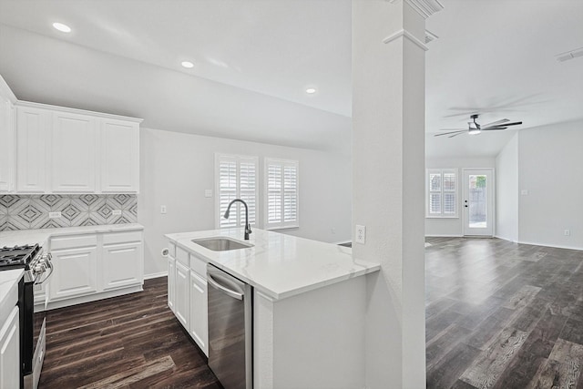 kitchen with sink, backsplash, white cabinets, dark hardwood / wood-style flooring, and stainless steel appliances