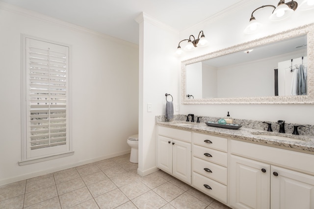 bathroom with tile patterned floors, toilet, vanity, and crown molding