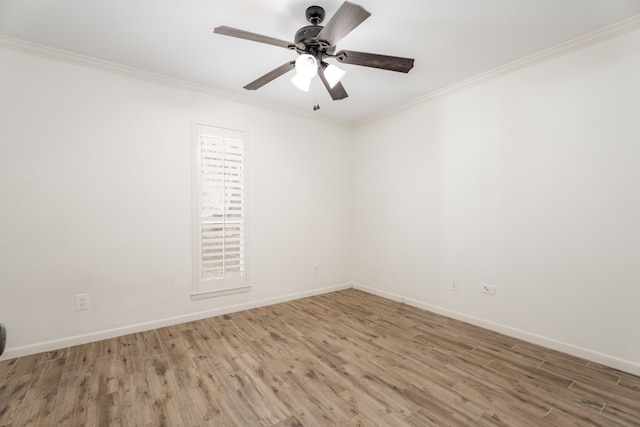 empty room with ceiling fan, plenty of natural light, crown molding, and hardwood / wood-style flooring