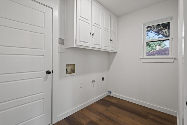 laundry area with hookup for a gas dryer, washer hookup, dark hardwood / wood-style flooring, electric dryer hookup, and cabinets