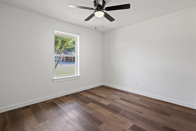 empty room with ceiling fan and dark hardwood / wood-style floors