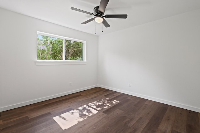 empty room featuring ceiling fan and dark wood-type flooring