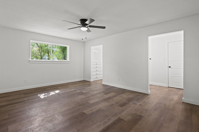 spare room with ceiling fan and dark hardwood / wood-style flooring