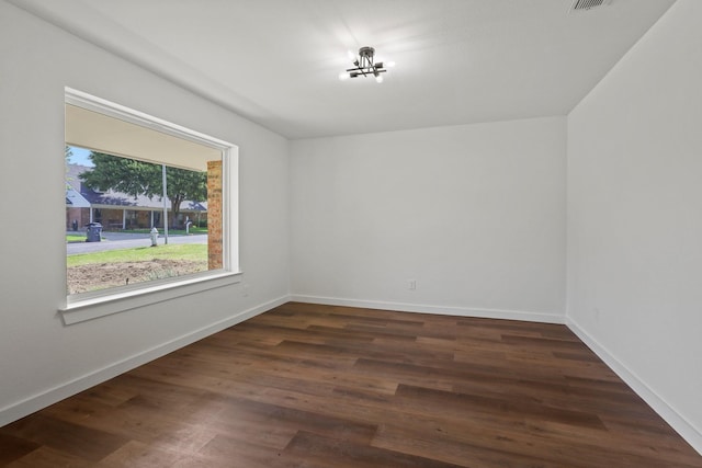 unfurnished room with dark hardwood / wood-style floors