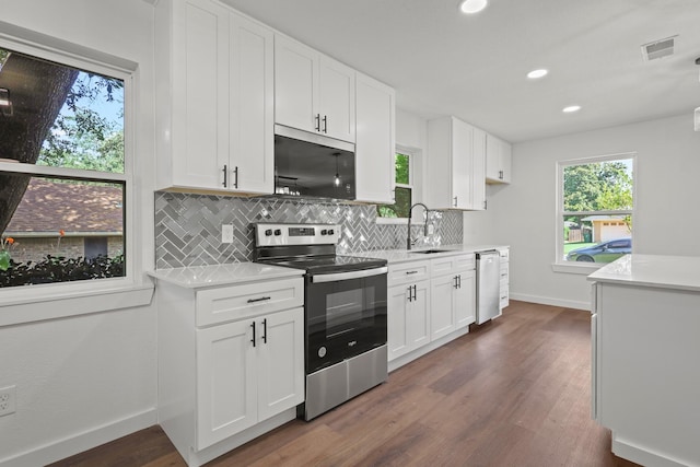 kitchen featuring decorative backsplash, sink, white cabinetry, dark wood-type flooring, and stainless steel appliances