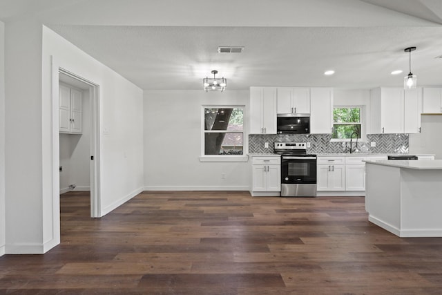 kitchen featuring white cabinetry, appliances with stainless steel finishes, dark hardwood / wood-style flooring, hanging light fixtures, and sink