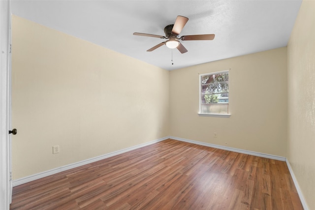 unfurnished room with hardwood / wood-style flooring and ceiling fan