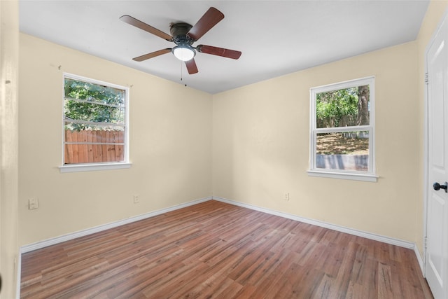 unfurnished room featuring ceiling fan, plenty of natural light, and hardwood / wood-style floors