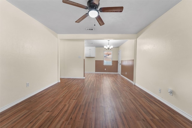 unfurnished living room featuring dark wood-type flooring and ceiling fan with notable chandelier