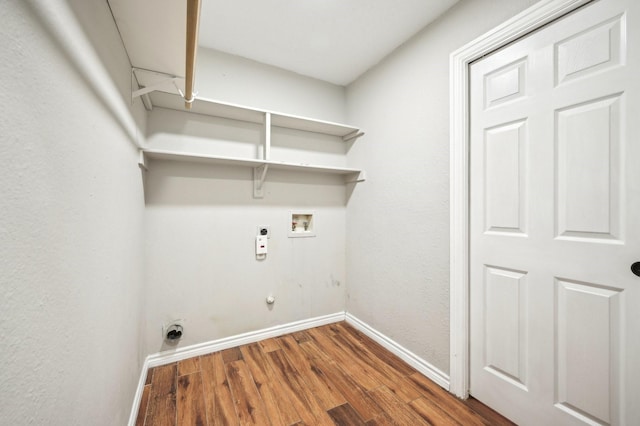 laundry area featuring wood-type flooring, hookup for a washing machine, electric dryer hookup, and hookup for a gas dryer