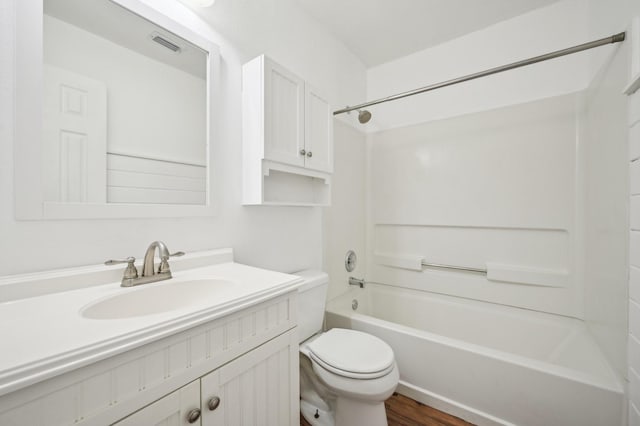 full bathroom featuring shower / bathtub combination, hardwood / wood-style flooring, toilet, and vanity